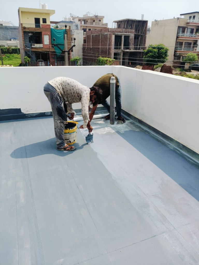 Contractors applying elastomeric terrace coating